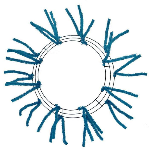 The Pencil Wreath Turquoise Non-Metallic 24 XX750441 features a circular wire frame with evenly spaced blue pipe cleaners extending outward like sun rays, creating a striking, minimal, and symmetric design.
