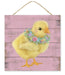 A 10 square sign features a yellow chick with a floral wreath against a pink wooden backdrop, complete with a rope hanger.