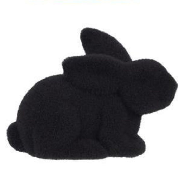 A matte black silicone mold shaped like a rabbit with a simple, stylized silhouette, perfect for creating vibrant polystyrene or nylon designs. Captures the charm of an 8.5L x 6H flocked laying rabbit in six assorted colors: purple, pink, black, green, orange, and turquoise (HE722999).