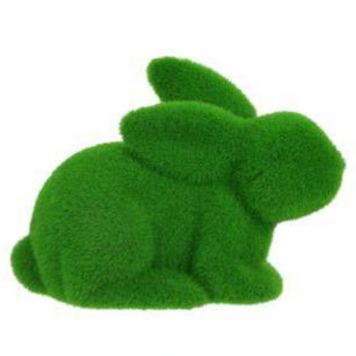 The 8.5L X 6H Flocked Laying Rabbit boasts a green hue like grass or moss, with a flocked soft texture. Crafted from polystyrene and nylon, it features rounded shapes forming the body, head, ears, and tail. Available in 6 colors: purple, pink, black, green, orange, and turquoise.