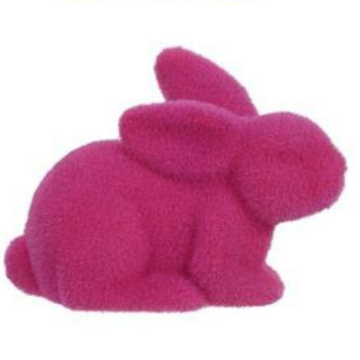The 8.5L x 6H flocked laying rabbit in vibrant pink features a velvety polystyrene/nylon texture, elegantly set on a white background.