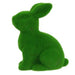 The 10H x 8.25L Flocked Sitting Rabbit, made from polystyrene/nylon, features a grass-textured surface with upright ears and a soft appearance. Available in purple, pink, black, green, orange, and turquoise (HE723199).
