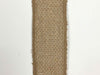 A 1.5" wide Faux Natural Burlap Ribbon (X501409-32B), featuring coarse woven texture and frayed edges, is placed vertically against a plain white background.