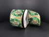 Two rolls of 2.5X10Y Natural Wood Linen/Wreaths-Merry Christmas ribbon (71193-40-15), featuring green wreaths, red berries, and festive text on a wood-patterned background, displayed on a plain black surface.