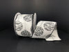 The White Satin/Silver Zebra-Cheetah Glitter Ornaments ribbon, measuring 2.5X10Y, features animal prints and Christmas ornaments, crafted from synthetic wired material, partially unrolled against a plain black background.