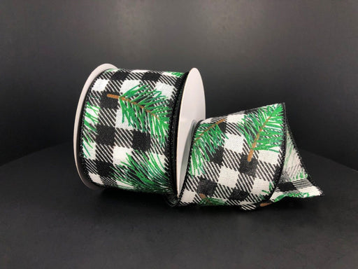 A partially unrolled 2.5x10Y ribbon, named Black-White Buffalo Plaid Linen/Pine Needles, displays a buffalo plaid pattern with green pine branches against a dark background.