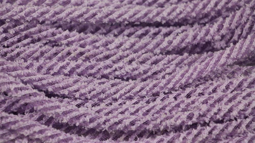 Close-up of 8Mm X 20Yd Snowdrift Deco Flex Tubing in Orchid (RE322495), with multiple twisted cords arranged in wavy, parallel rows for a repetitive pattern.