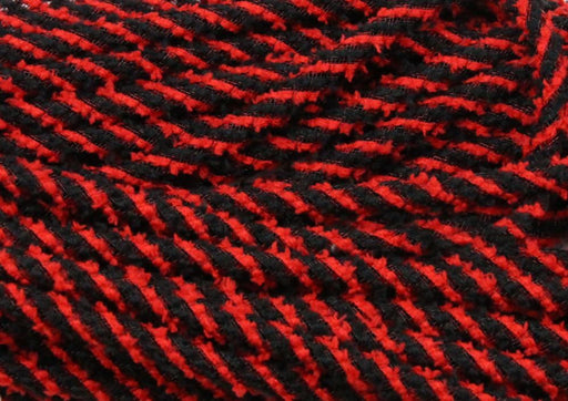 Close-up of 8Mm X 20Yd Snowdrift Deco Flex Tubing (Red/Black, RE3225K1) reveals soft woven fabric with bold red and black diagonal stripes and prominent raised stitches, evoking a vivid winter snowdrift pattern.