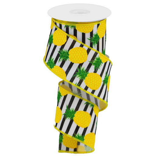 The 2.5 Black White Stripe Pineapple Ribbon RGC1107J3 features vivid yellow pineapples and lush green leaves on a bold black and white stripe background. Made from durable polyester, its partially unwound spool showcases the impressive design.