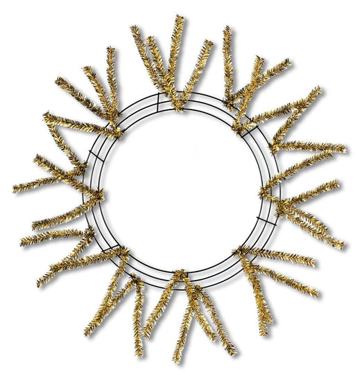 The 24 Pencil Work Wreath Metallic Gold XX751108 is a decorative wreath with a sunburst design, featuring sparse golden tinsel radiating from a simple wire frame against a plain white background.