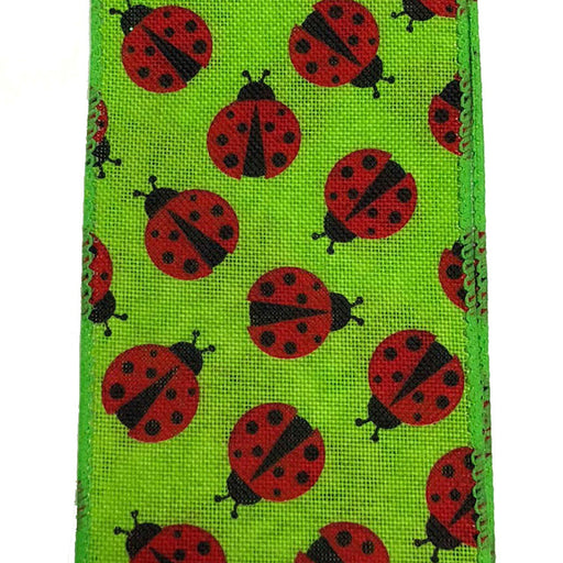 The 2.5 Green Linen Red Black Ladybug Ribbon Q917640-29 features a whimsical, vibrant green fabric with red ladybugs adorned with black spots. The ladybugs are evenly spaced, oriented in various directions, and the fabrics subtle texture is slightly visible.