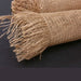 A close-up shows two 10 Dark Natural Frayed Burlap Mesh Rolls (XB97010-15) on a black surface, highlighting their coarse texture and dark natural brown color.