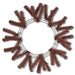 The 24" Work Wreath Chocolate Brown XX748840 features a symmetrical design with artificial pine branches partially covering the chocolate brown frame. The branches extend outward evenly, forming a perfect circular pattern while leaving the center empty.