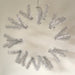 The 24 Work Wreath Silver Metallic is showcased on a plain background, featuring silver tinsel with metallic branches. Its sparse, modern design has evenly spaced tinsel sections meticulously attached to a sturdy metal frame, reflecting expert craftsmanship.