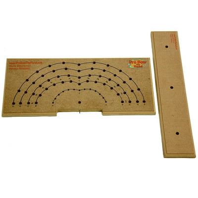 The Large Pro Bow The Hand Bowmaker is a wooden tool designed for precision drilling, featuring a semi-circular pattern of holes and alignment markings. It includes an additional rectangular piece on the right side with alignment holes, making it ideal for creating accurate bow placements.