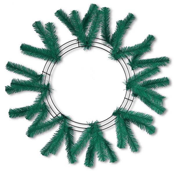 The Work Wreath 24" Emerald Green XX748806 features sparsely attached, evenly spaced artificial pine branches on a 24-inch frame, shown against a white background.